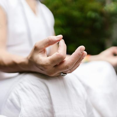 Person hands resting in a meditation mudra
